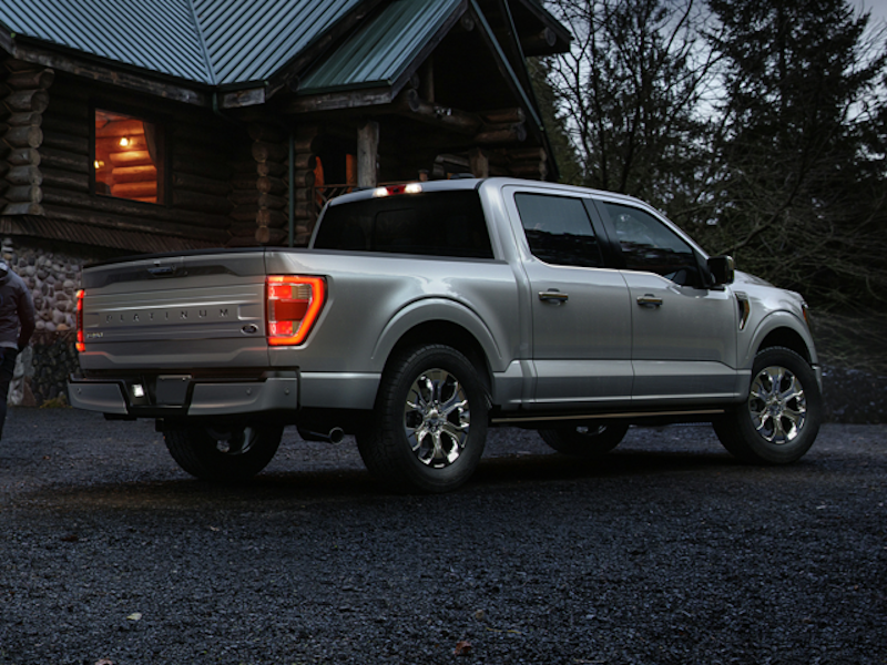 The 2024 Ford F-150 parked at a log cabin
